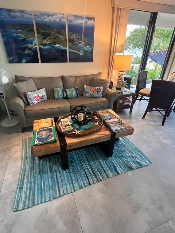 Living room with sofa, coffee table and patio doors in this St. Thomas condo near the St. John ferry