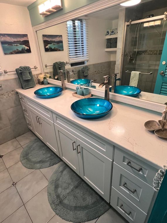 Double-sink vanity stocked with plush towels and toiletries in the St. Thomas condo with a view of St. John